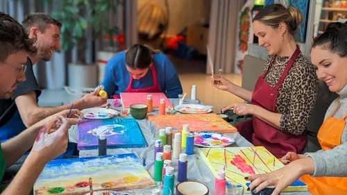 People painting together at a table.