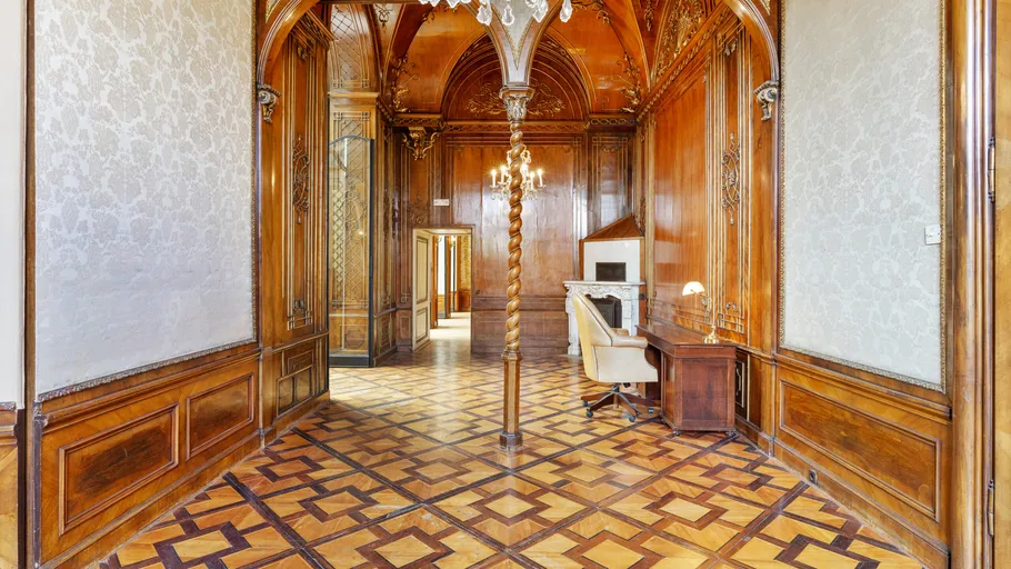 Luxurious wooden room with ornate ceilings.