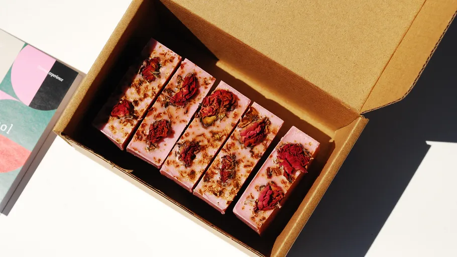 Pink soap bars with flowers in a box.