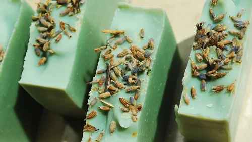 Green soap bars topped with lavender buds.