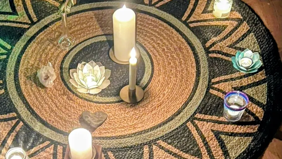 Candles arranged on a decorative rug.