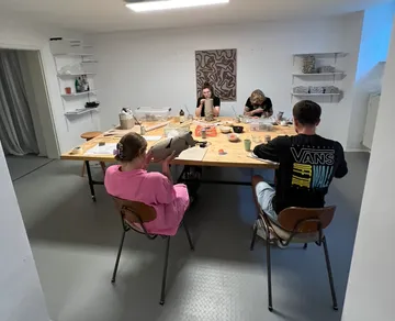 Four people working at a large table.