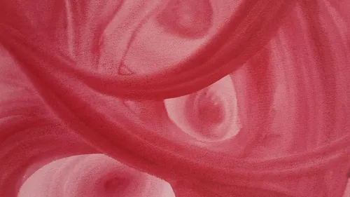Abstract red swirls in close-up view.