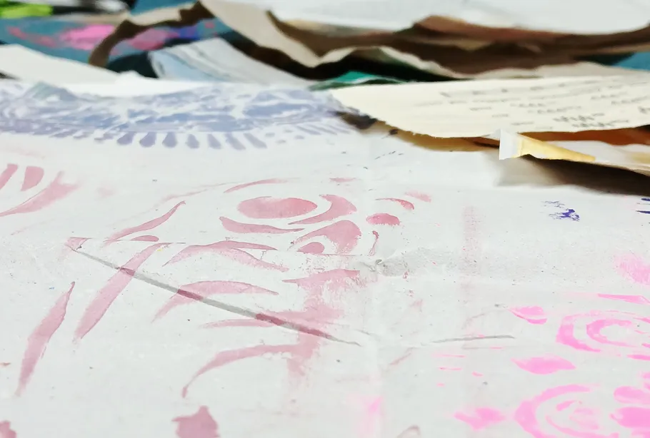 Close-up of colorful painted papers on a table.