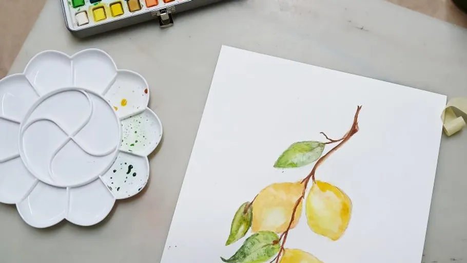 Watercolor painting of lemons with palette.