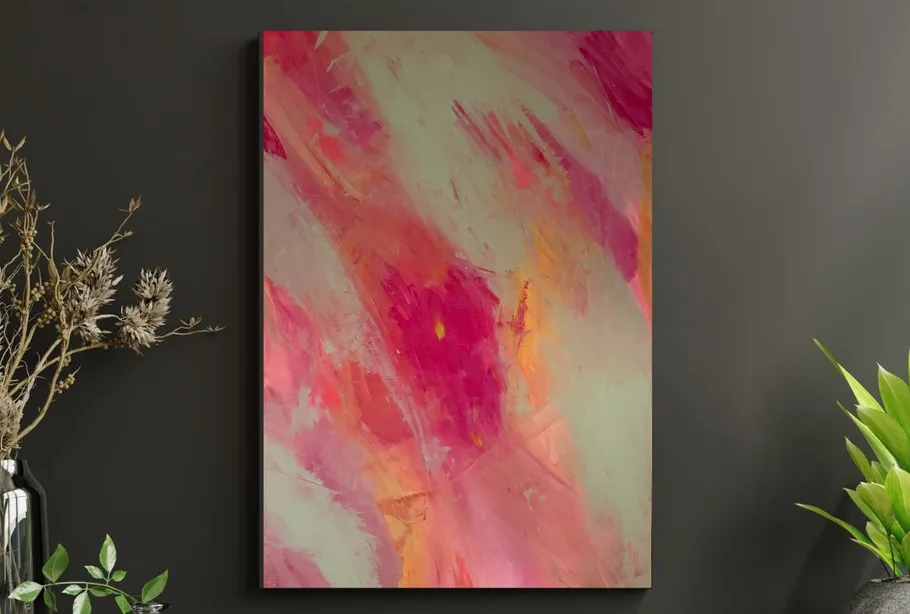 Abstract pink artwork on dark wall.