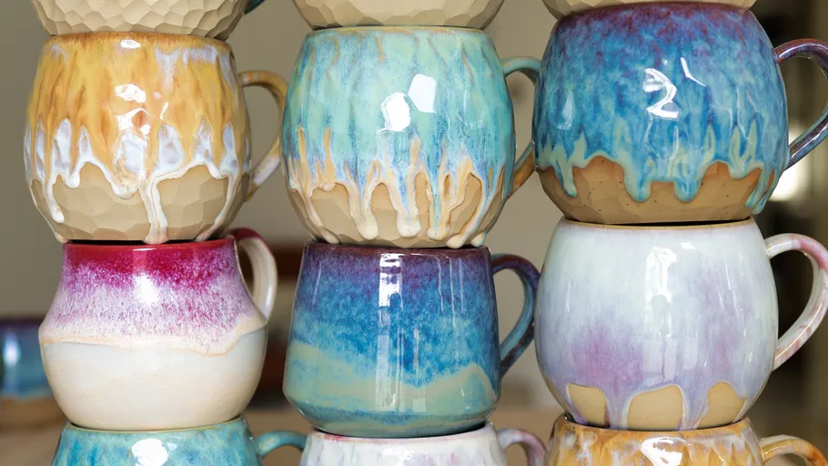 Colorful ceramic mugs stacked in pairs.