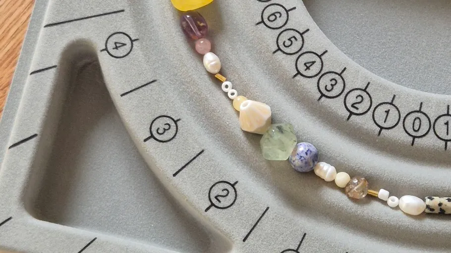 Beads arranged on a gray jewelry tray.