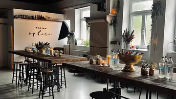 Rustic event space with tables and decorations.