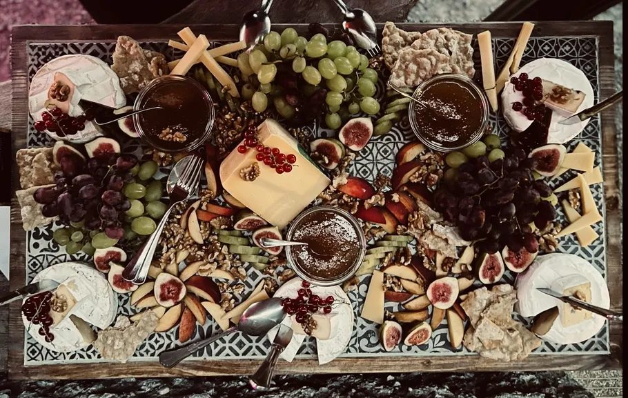 Cheese platter with fruits and dips.