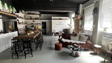 Cozy loft living area with kitchen and seating.