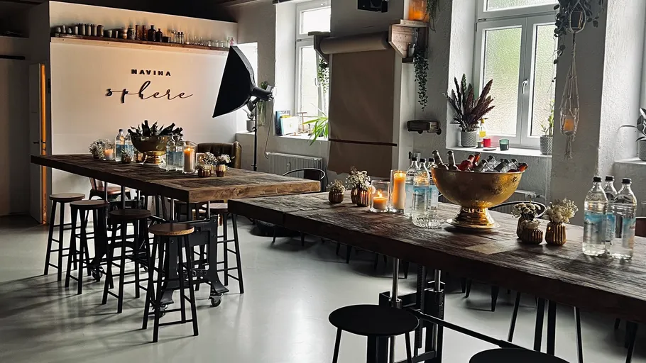 Holztische mit Hockern, Flaschen und Dekorationen im Studio.