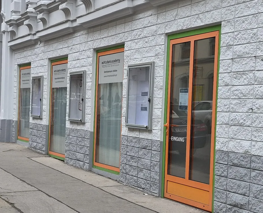 Building facade with orange-framed doors.
