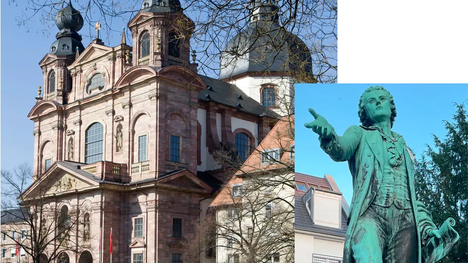 Barockkirche neben Bronze-Statue im Freien.