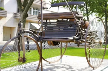 Vintage automobile with three wheels outdoors.