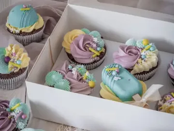 Colourful cupcakes in a box decorated with icing