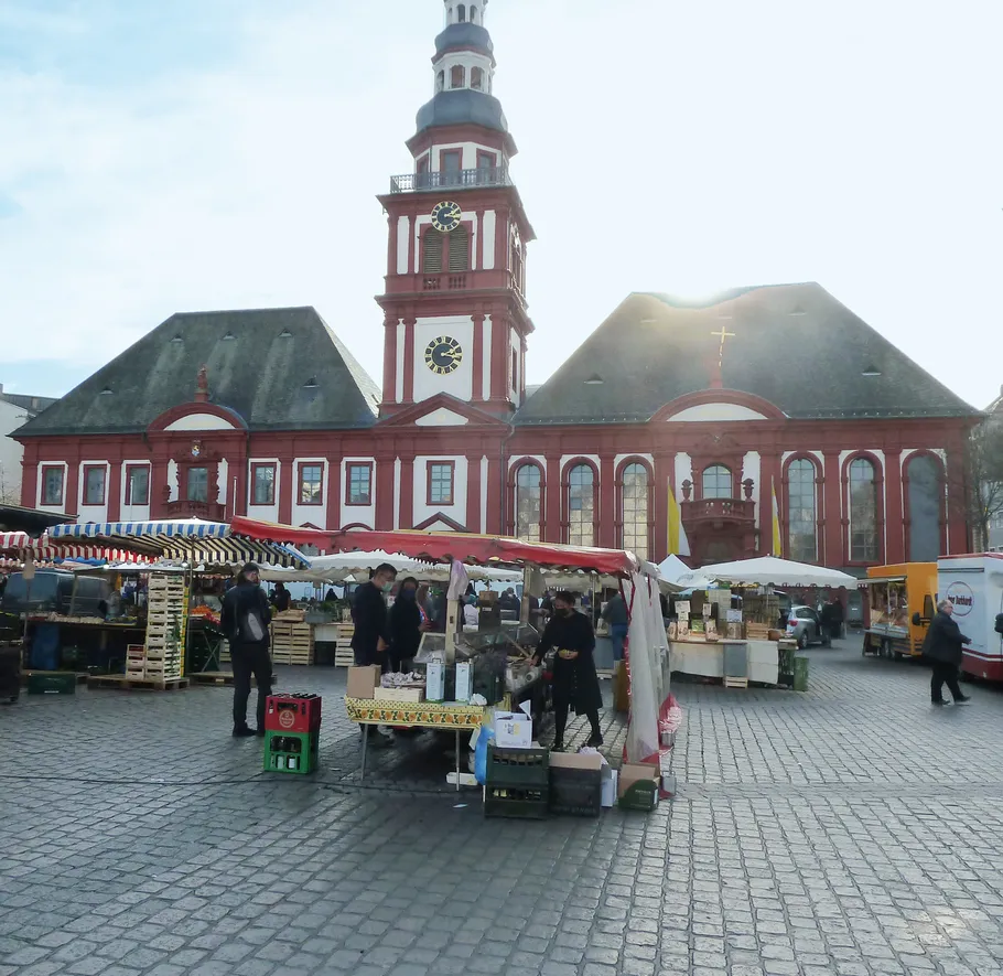 Marktstände vor einem historischen Gebäude.