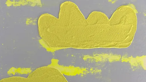 Abstract yellow shapes on textured gray background.