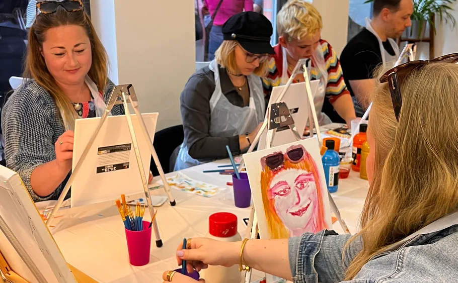 People painting at a social event.
