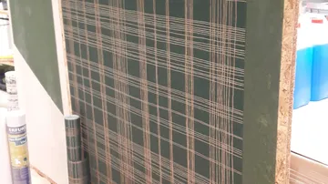 Plaid wallpaper pattern on display board.