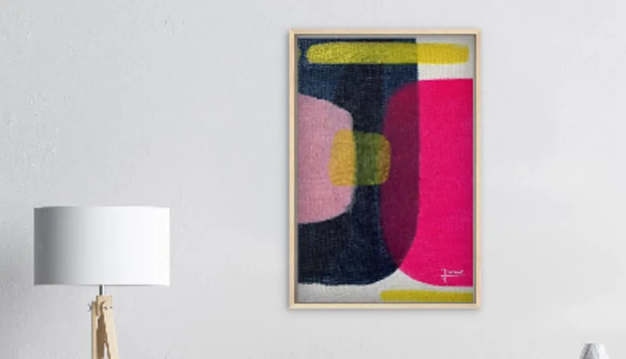 Abstract painting on wall beside lamp.