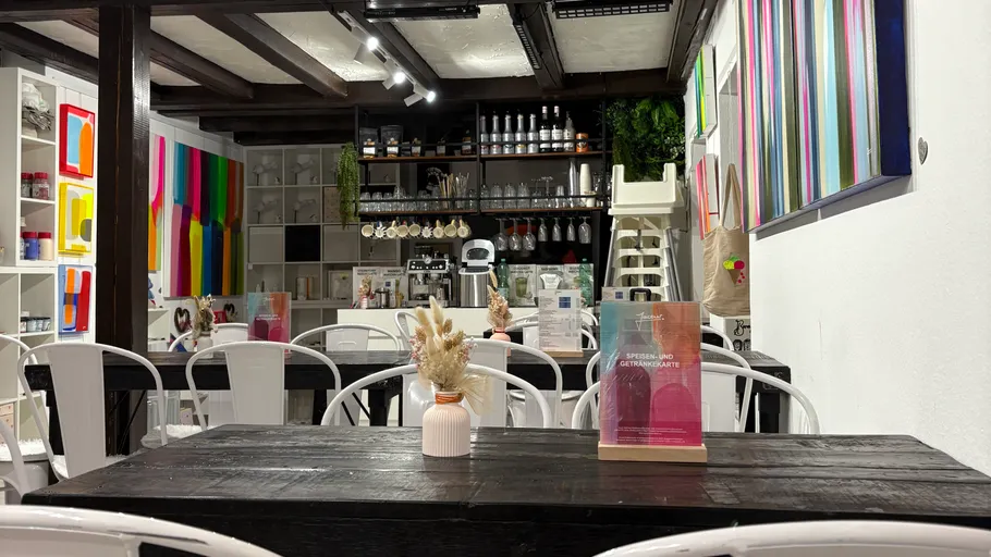 Cafe interior with colorful art displays.