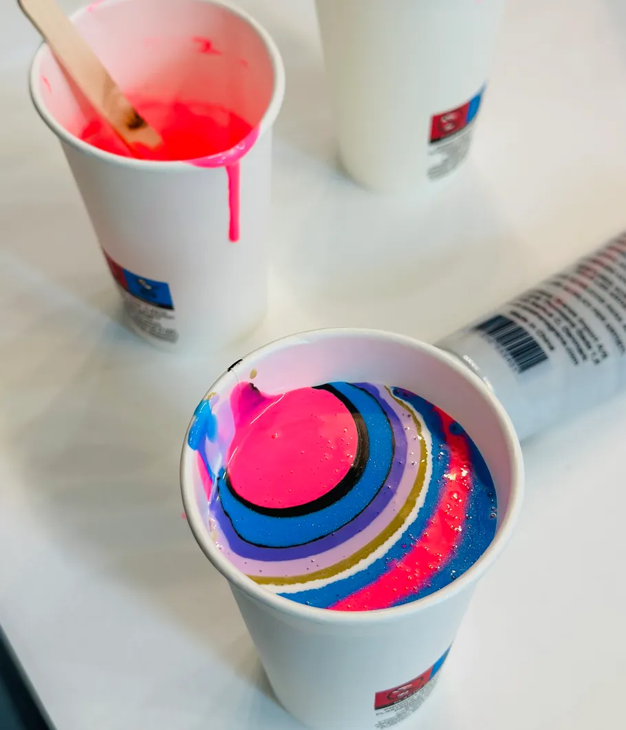 Paint cups with colorful swirling pattern.