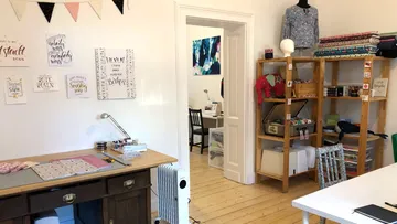 Craft room with sewing materials and decorations.