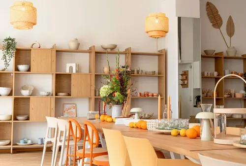 Dining area with wooden shelves and table.