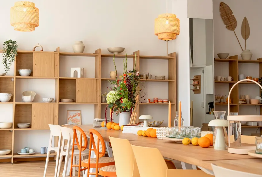 Dining area with wooden shelves and table.