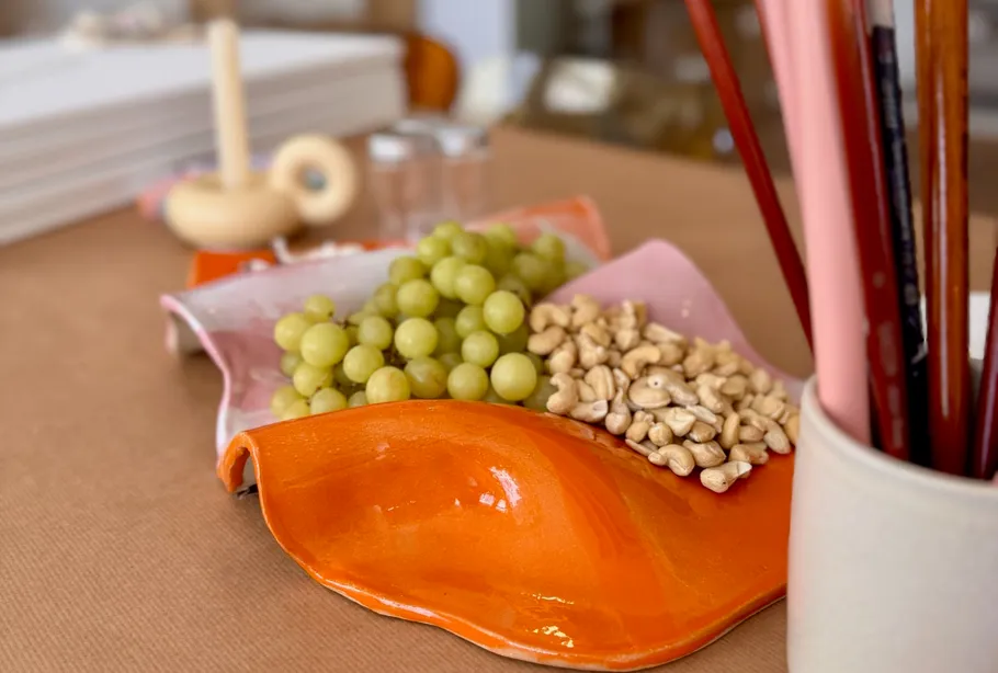 Grapes and nuts on a colorful platter.
