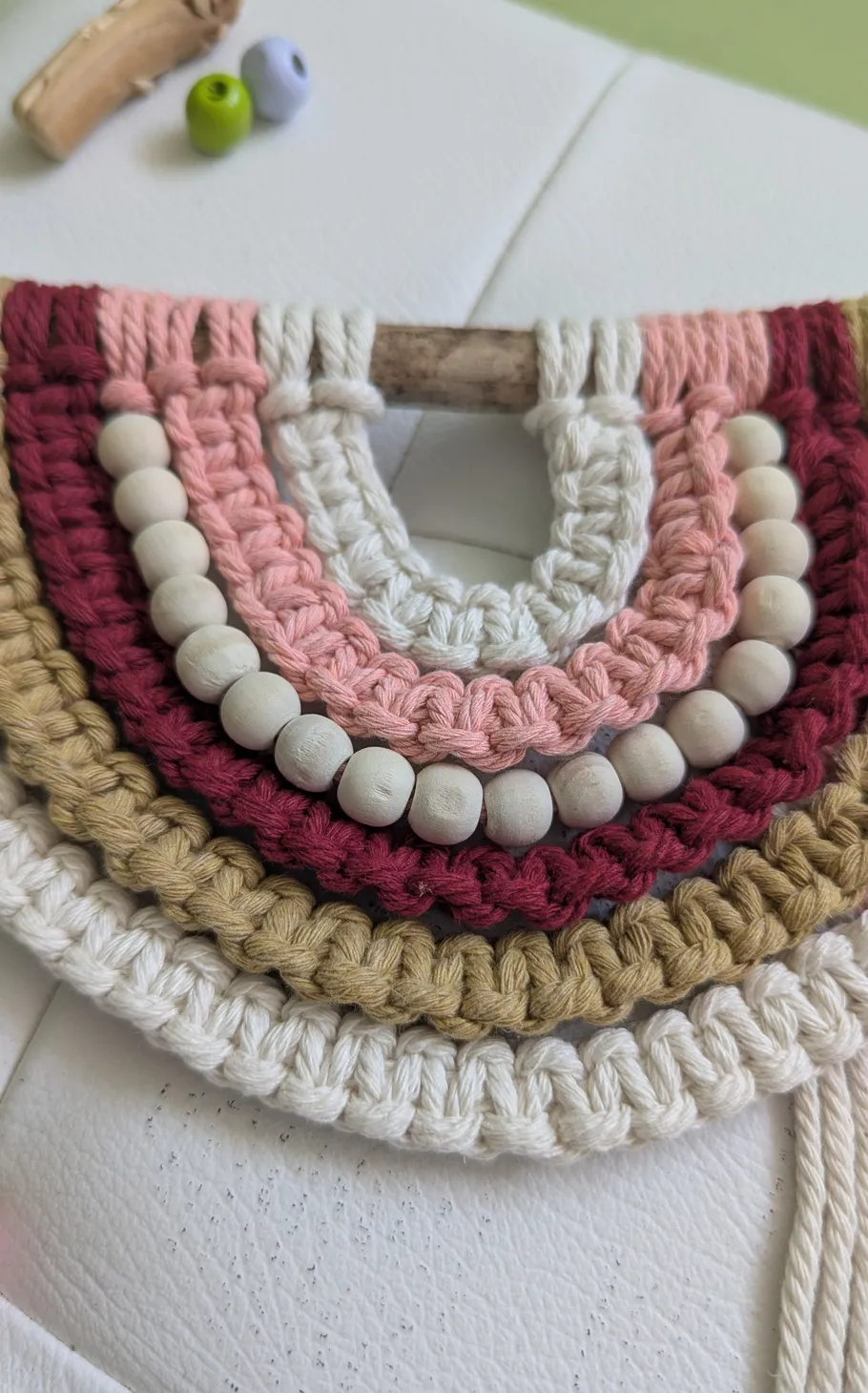 Crochet and beads on a wooden stick.