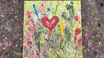 Heart-shaped abstract painting with flowers.