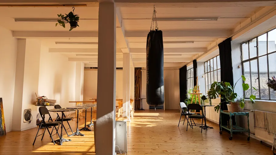 Loft space with chairs and punching bag.