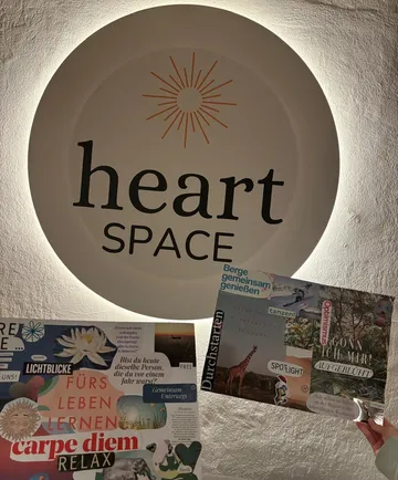 Two collage boards in front of 'heart SPACE' sign.
