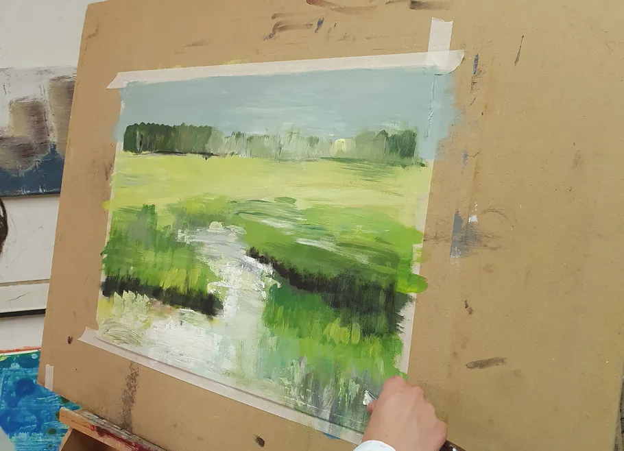 Hand painting landscape on canvas easel.