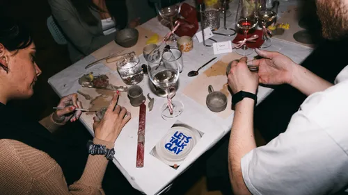 Two people crafting clay at a table.