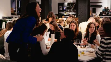 People talking and dining in a restaurant.