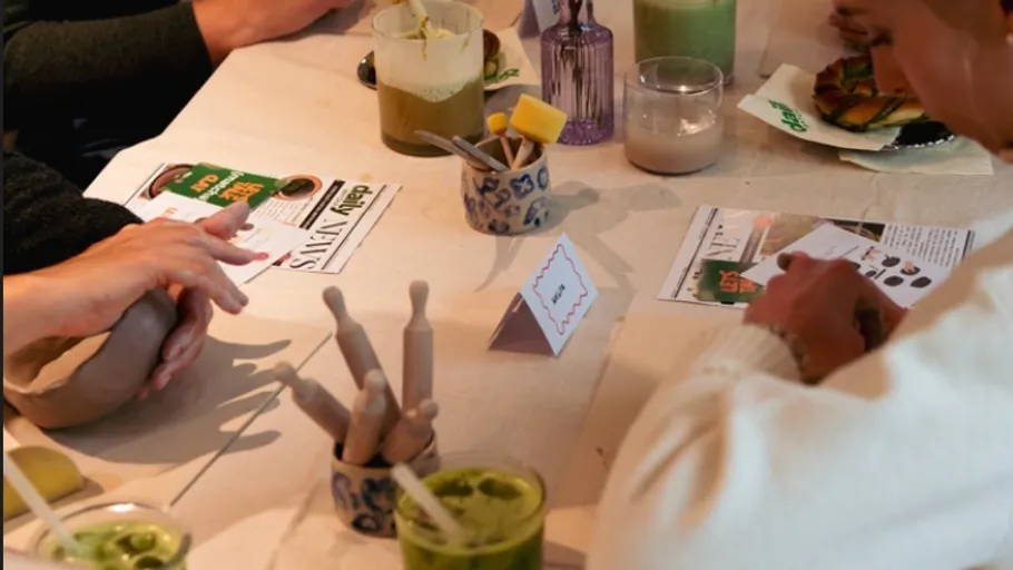 People crafting at a table with tools.