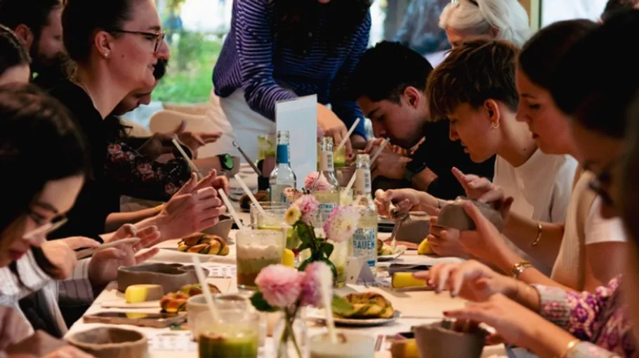 People crafting together at a table indoors.