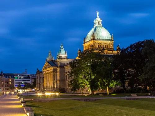 Historic building with illuminated roof at dusk.