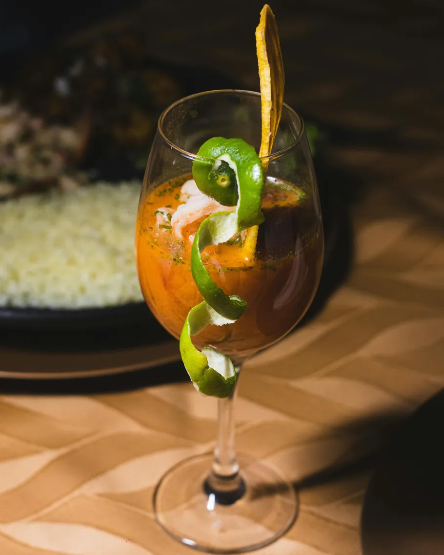 Glass with garnish on a table.