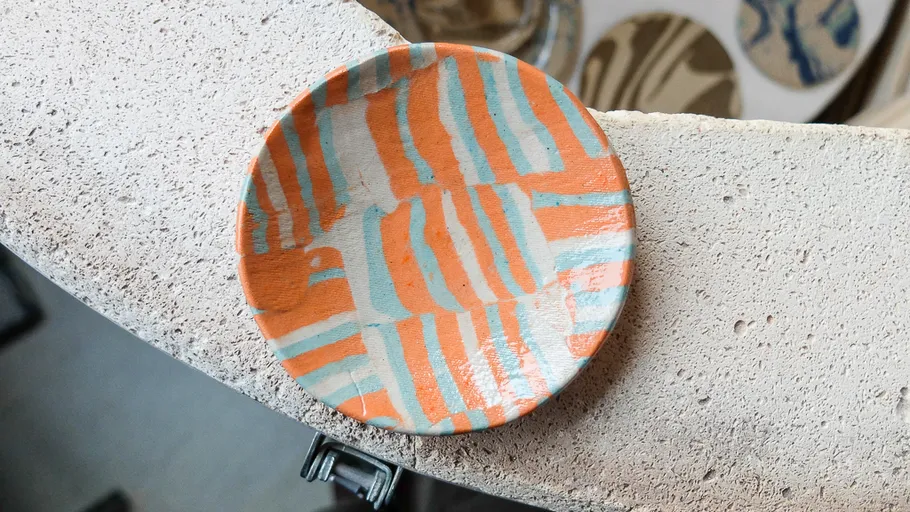 Colorful plate on textured stone surface.