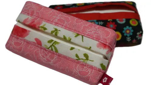 Two floral tissue holders placed on white background.