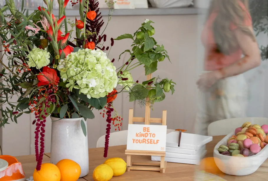Boquet with vibrant flowers on wooden table.