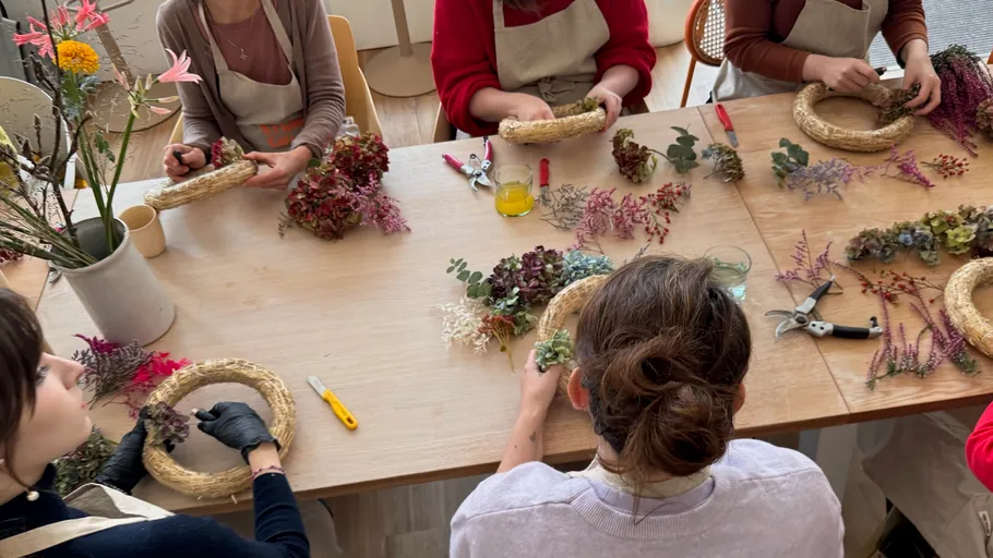 People crafting wreaths with dried flowers.