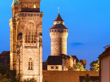 Two towers rise majestically in dusk light.