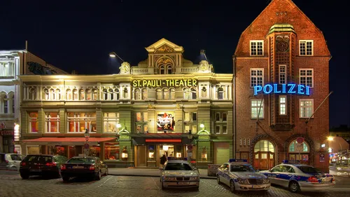 Theater and police station buildings at night.