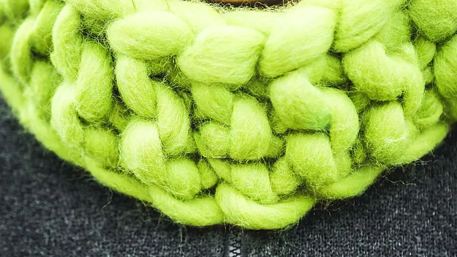 Bright green chunky knit scarf close-up.