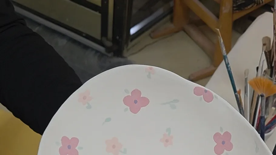 Painted ceramic plate with floral design.